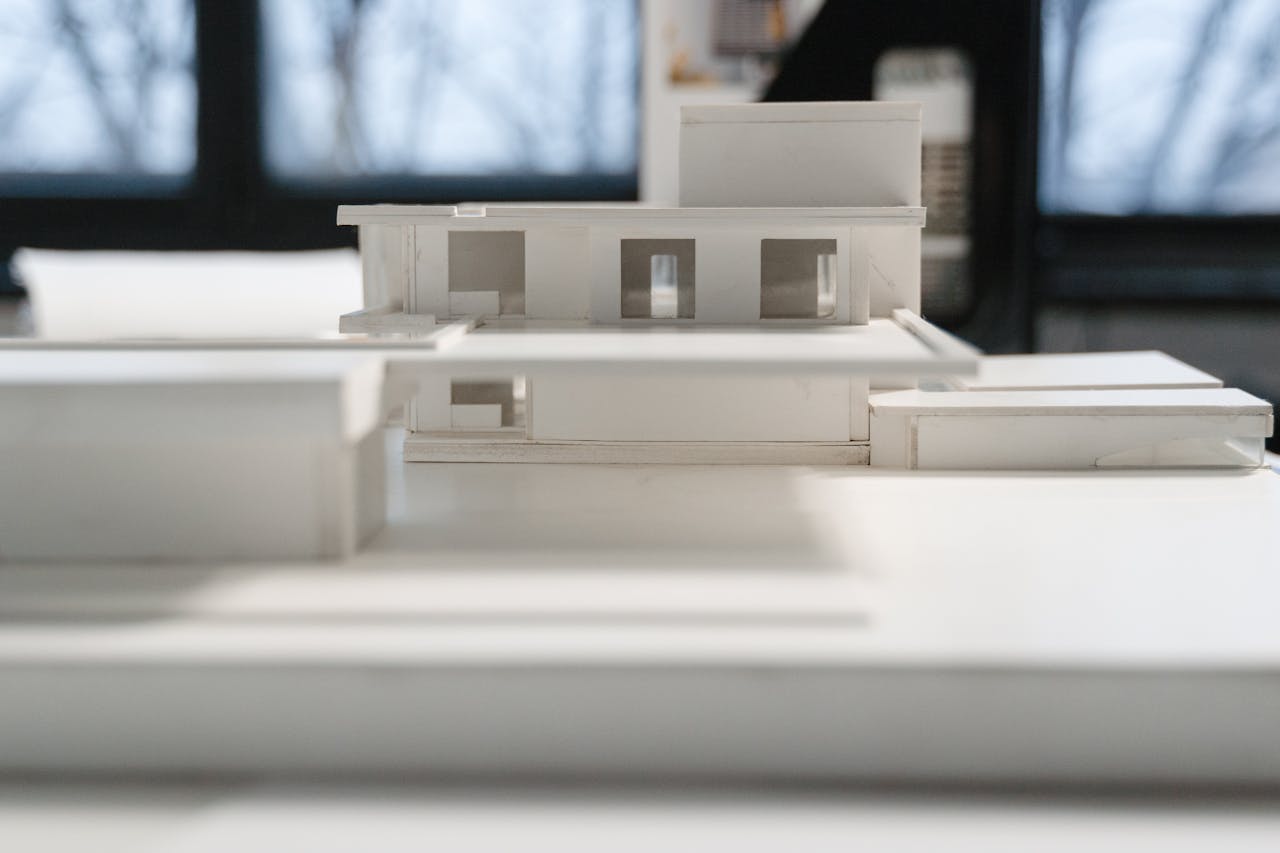 Detailed miniature architectural model indoors with natural light and modern design elements.